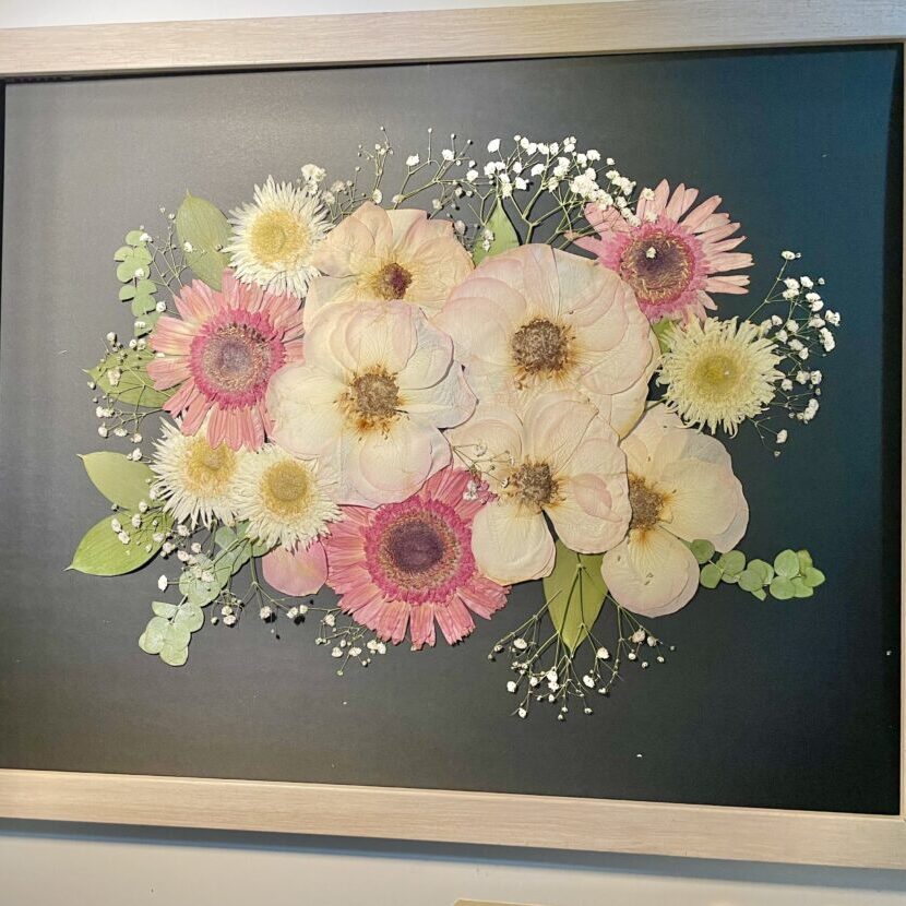 Frame pressed flower wedding bouquet on black background